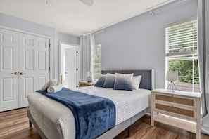 A bedroom with a bed, bedside tables, a window with blinds, and a door. - Family Disney Getaway w/ Private Pool & Resort Amenities (Kissimmee)