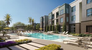 Ein modernes Hotel mit Swimmingpool, Liegestühlen und Palmen.