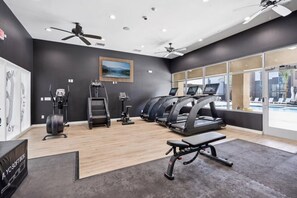 A gym with treadmills, elliptical machines, and a bench. - Landing | Stunning 1BD, Clubhouse, Gym (North Las Vegas)