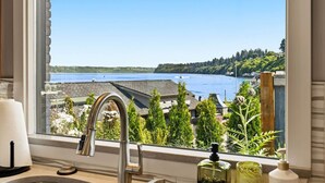 A bathroom with a view of a lake, a faucet, and a soap dispenser. - Luxury Waterfront Home walk to Downtown Gig Harbor (Gig Harbor)