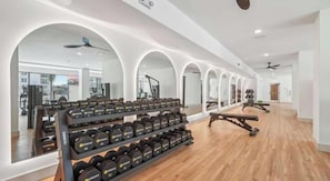 A gym with weightlifting equipment, mirrors, and exercise machines. - Landing | Modern 2BD, Clubhouse, Gym (San Antonio)