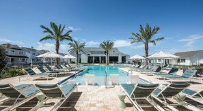 A pool area with lounge chairs, palm trees, and a building in the background. - Landing | Spectacular 3BD, Gym, Yoga Studio (Four Corners)