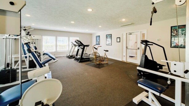 A gym with treadmills, stationary bikes, and weight machines. - Cozy 1-bedroom Pet Friendly Condo in Manistee.   Pool, Hot tub, 5 min to Beach! (Manistee)