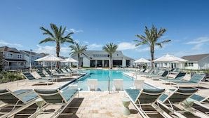 A pool area with lounge chairs and palm trees. - Landing | Chic 2BD, Gym, Yoga Studio (Four Corners)
