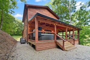 A wooden cabin with a covered porch and a staircase leading to a deck. - Private pickleball / basketball court, hot tub at the Red River Gorge KY (Campton)