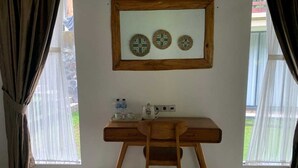 A room with a wooden desk, a chair, a mirror, and a window with curtains. - Cozzy OMAH JEGEG Tabanan Bali (Marga)
