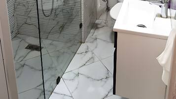 Shower, towels, soap, toilet paper