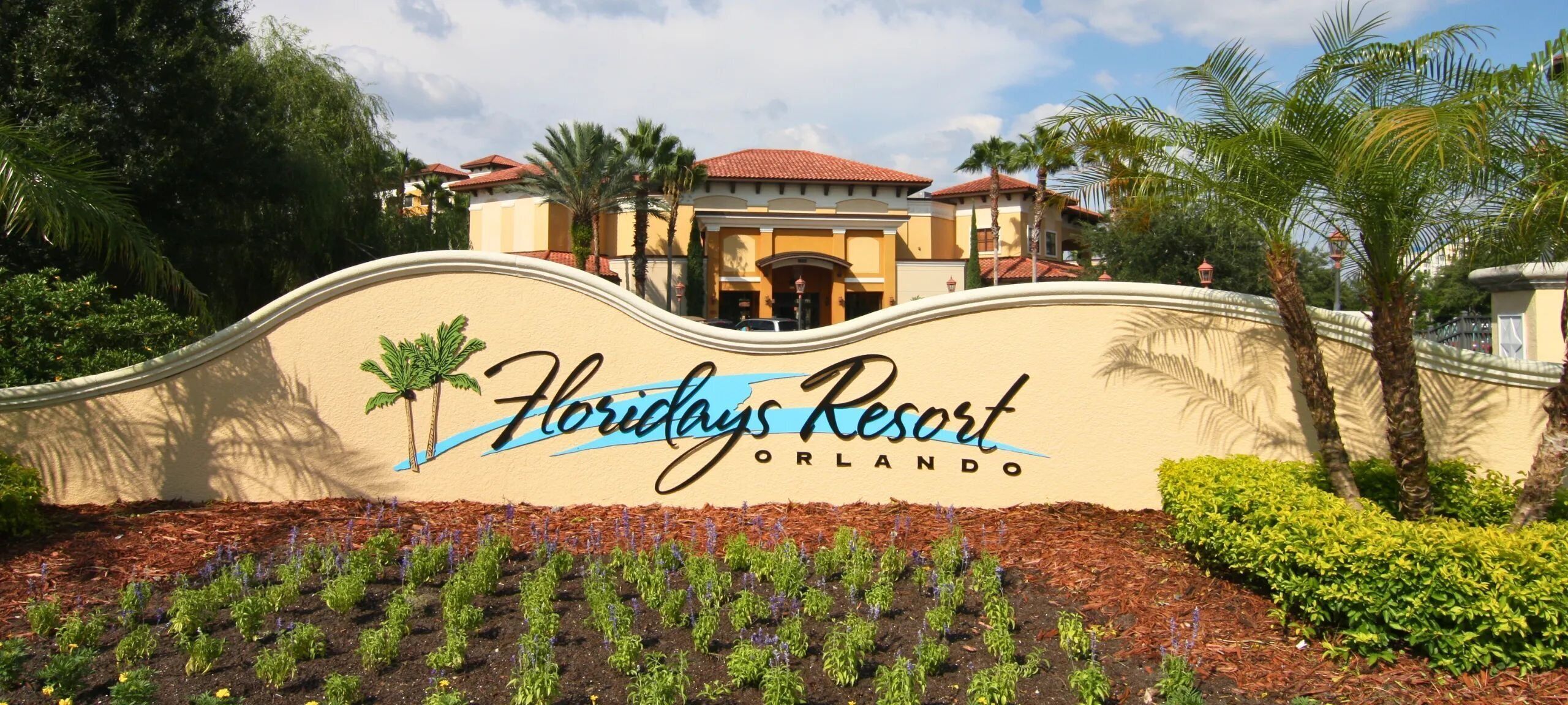 A sign for Floridys Resort in Orlando with a wavy top and palm trees.