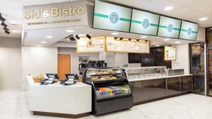 A coffee shop interior with a counter, menu boards, and a display case. - Apartment in Orlando, near the theme parks. (Orlando)