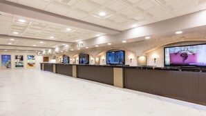 A reception area with a marble floor, a reception desk, and multiple screens displaying content. - Apartment in Orlando, near the theme parks. (Orlando)