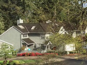 A two-story house with a front porch, a garage, and a driveway. - Bright and comfortable home (Portland)