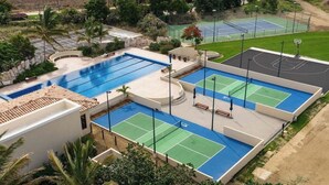 A pool area with multiple tennis courts, a basketball court, and a swimming pool. - Luxury Villa | Large Pool, Jacuzzi & Putting Green (Cabo San Lucas)