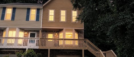 A two-story house with a balcony, a garage, and a staircase leading to the second floor.