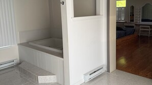 A bathroom with a bathtub, a shower, and a toilet. - Wonderful 3 bedroom house (Scott)