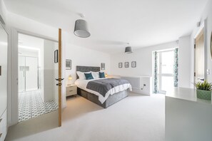 A bedroom with a bed, bedside tables, a radiator, and a window with curtains. - St Mary's Barn (Sleeps 4) - Stalbridge , Sherborne sleeps 4 guests  in 2 bedrooms (Stalbridge)