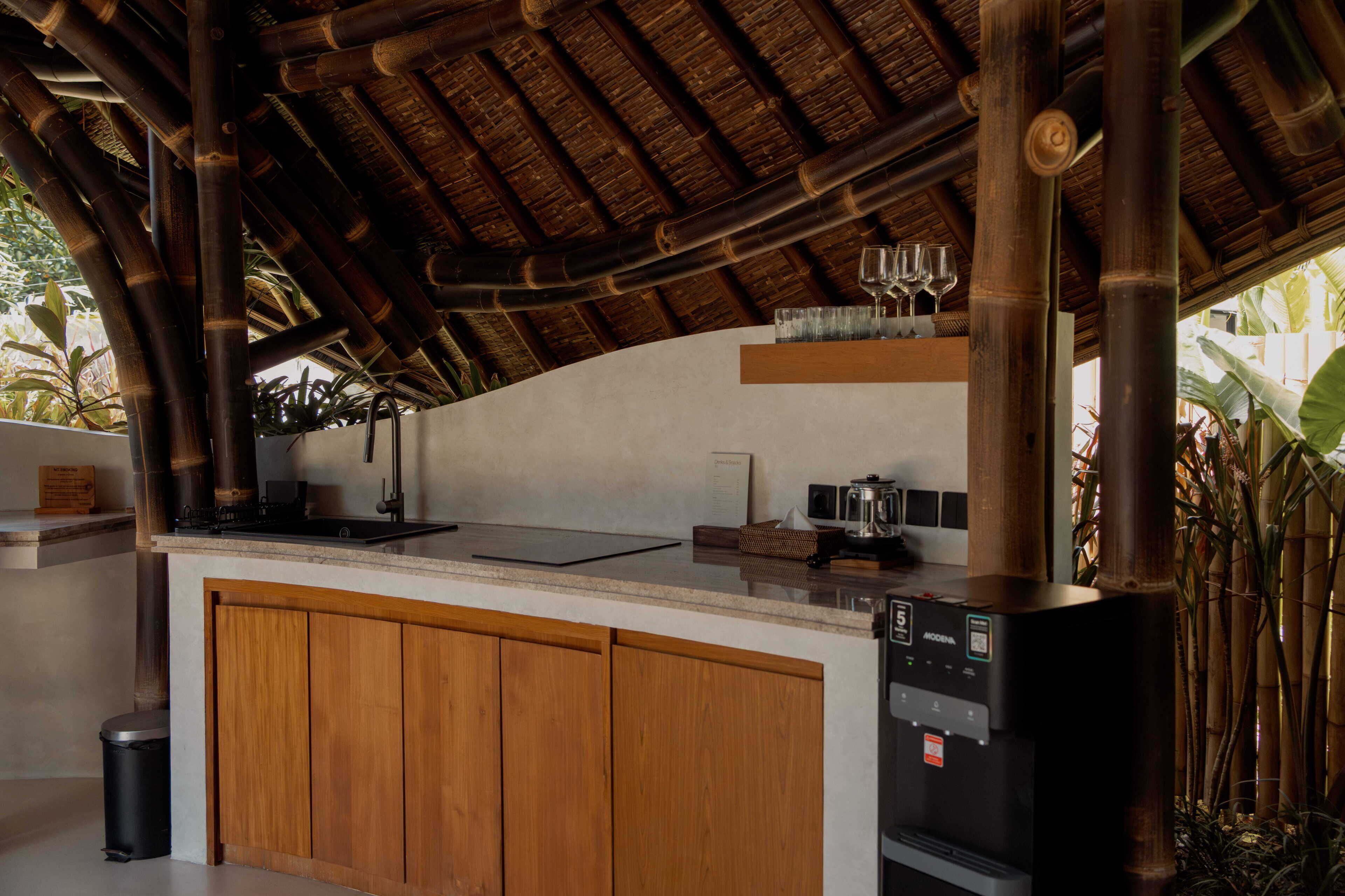 A kitchen with a wooden countertop, a coffee maker, and a microwave.