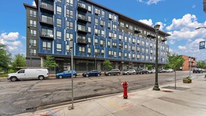 A multi-story building with a modern architectural style, featuring a series of balconies and large windows. - Modern 1BR Near Downtown | Walkable City Stay (Minneapolis)