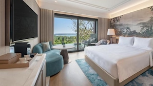 A hotel room with a large bed, a seating area, a TV, and a view of the outdoors. - Kate Hotel Special Class (Istanbul)