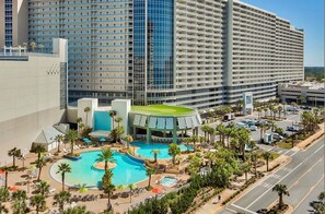 A hotel with a large swimming pool, multiple floors, and a parking area. - Gulf-View Resort Condo with 5 Pools! Walk to Beach (Panama City)