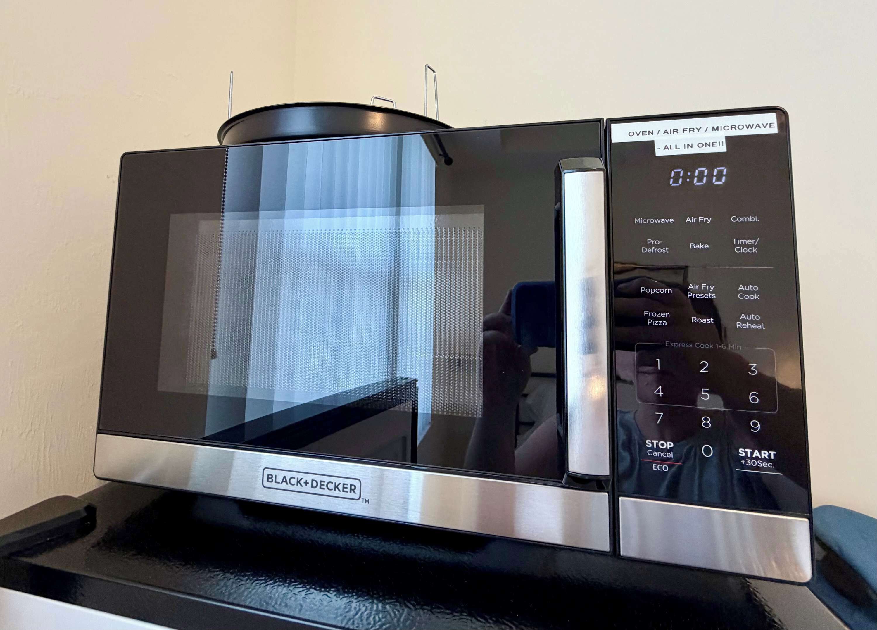 A BLACK+DECKER microwave oven with a digital display and control panel.