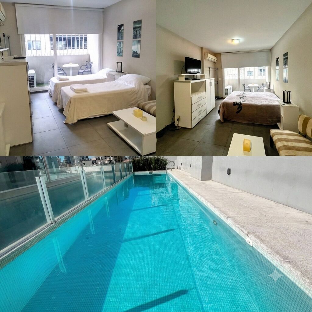A hotel room with a bed, a desk, a TV, and a balcony with a table and chairs.