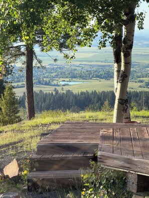 A wooden deck with steps leading to a scenic overlook. - Patchwork Acres, dog friendly with an amazing view of the Camas Prairie. (Grangeville)