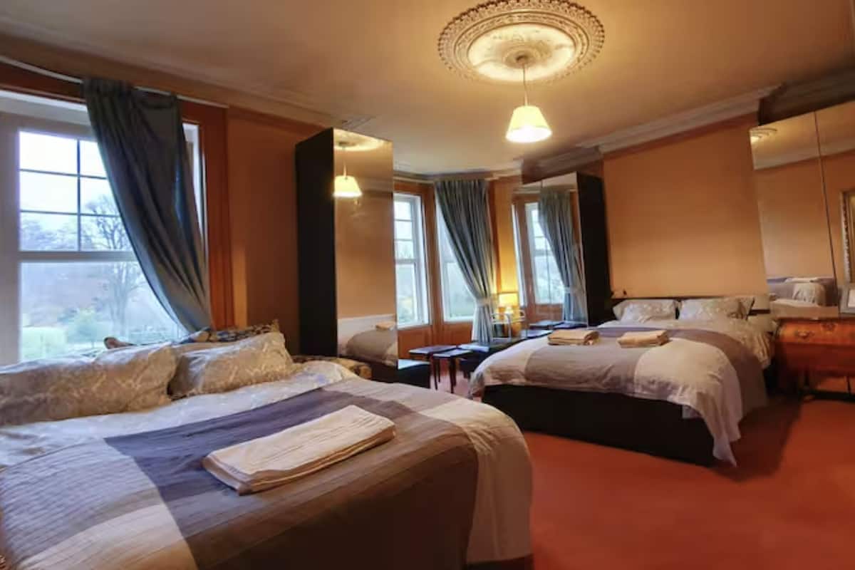 Una habitación de hotel con dos camas, un escritorio y una silla.