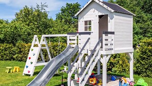 A playhouse with a slide, stairs, and a small porch. - 2 bedroom beautiful home in Mrzezyno (Mrzezyno)
