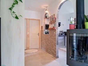 A modern kitchen with a tiled backsplash, a built-in oven, and a black range hood. - Villa Le Cercle by Interhome (Saint Paul de Vence)