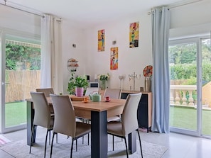 A dining area with a wooden table, chairs, and a potted plant. - Villa Le Cercle by Interhome (Saint Paul de Vence)