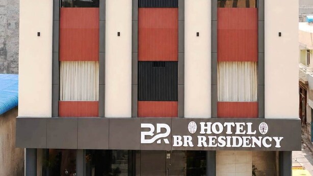 A hotel with a modern facade, three arched windows, and a prominent logo. - Hotel BR Residency (Bikaner)