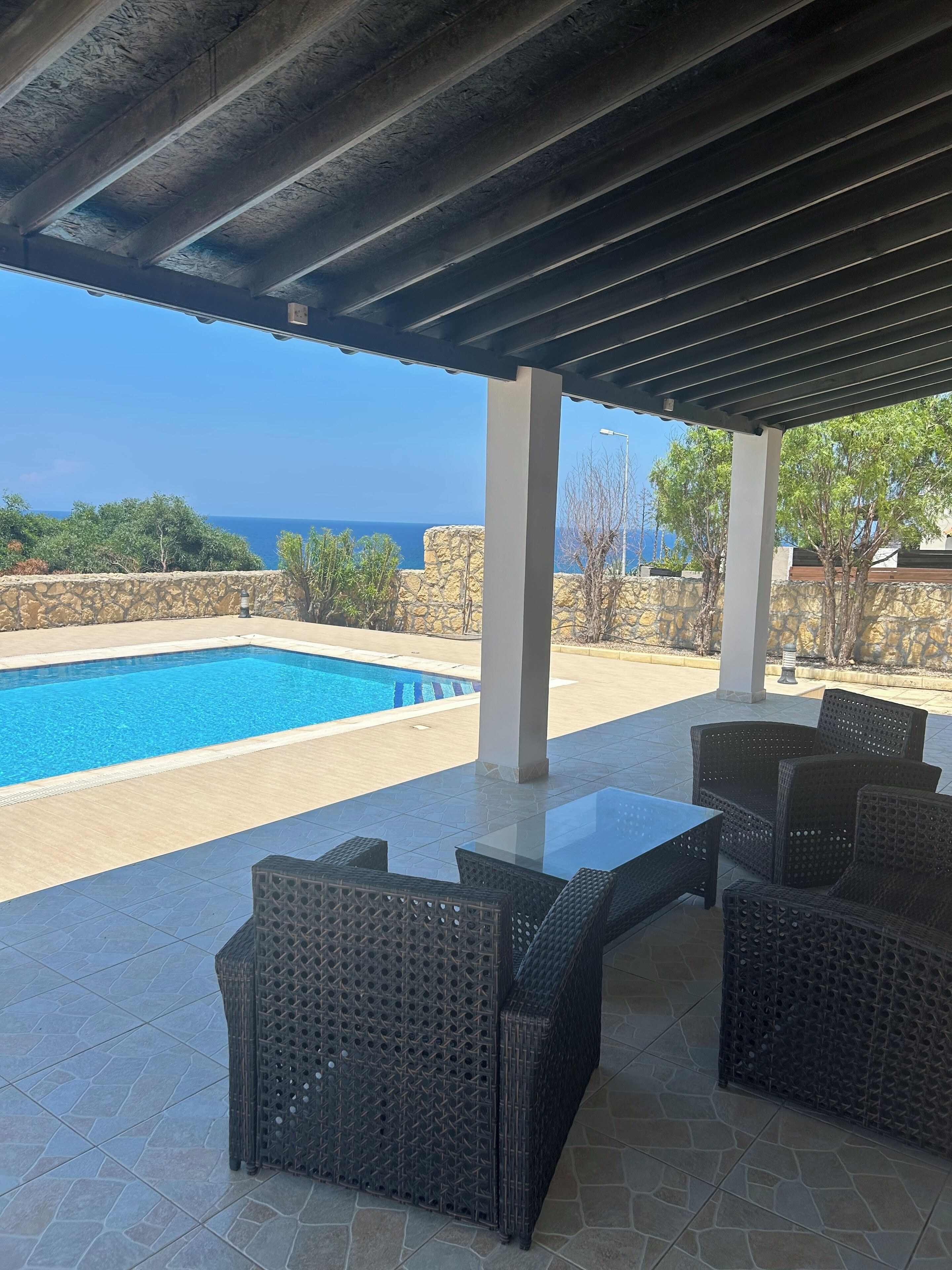Ground floor patio area overlooking pool and Mediterranean