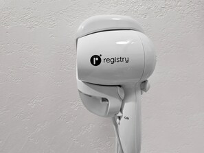 A white security camera mounted on a wall with the logo 'P registry' and an 'Off' switch.