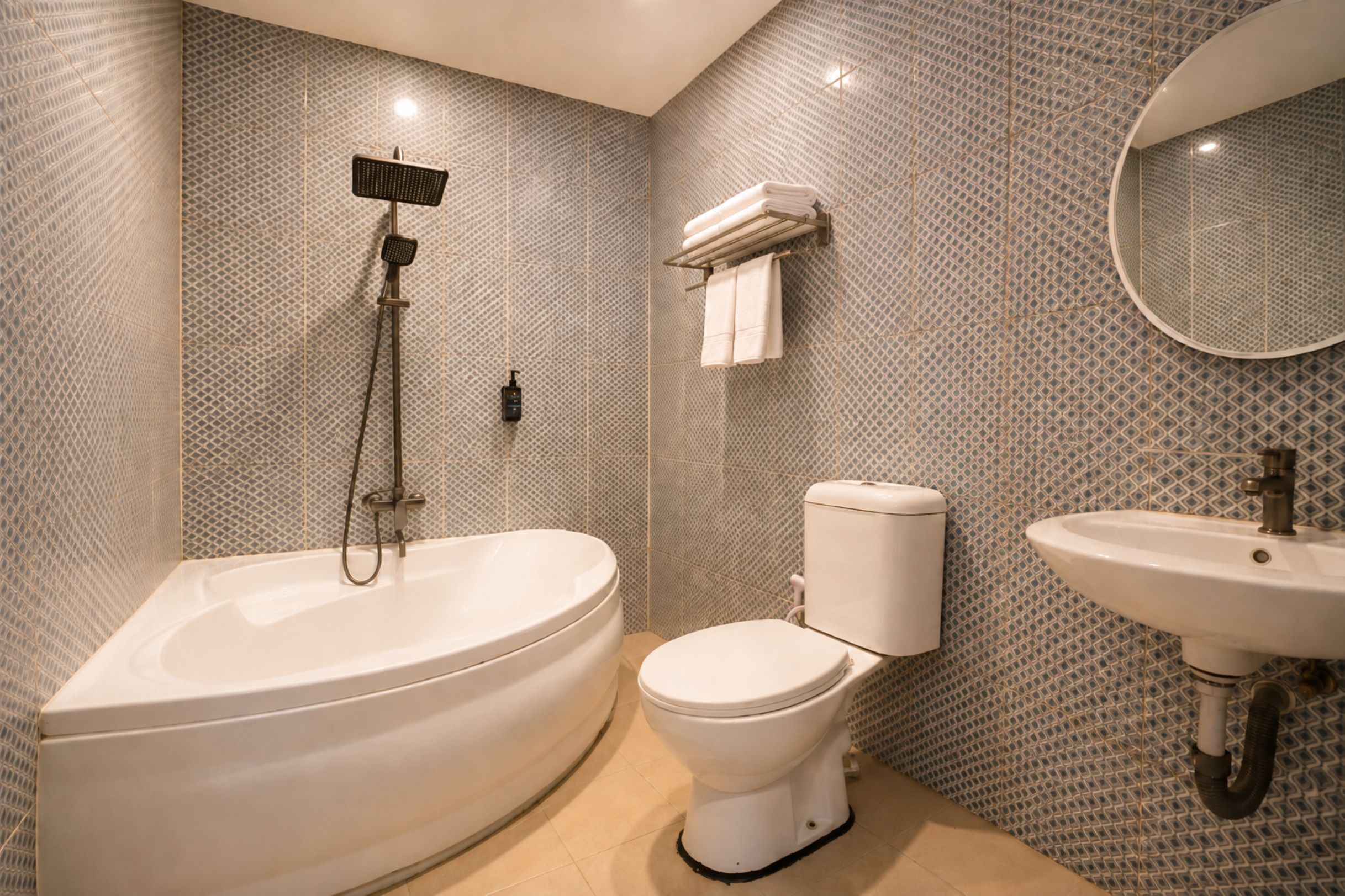 A bathroom with a freestanding bathtub, a toilet, and a sink.