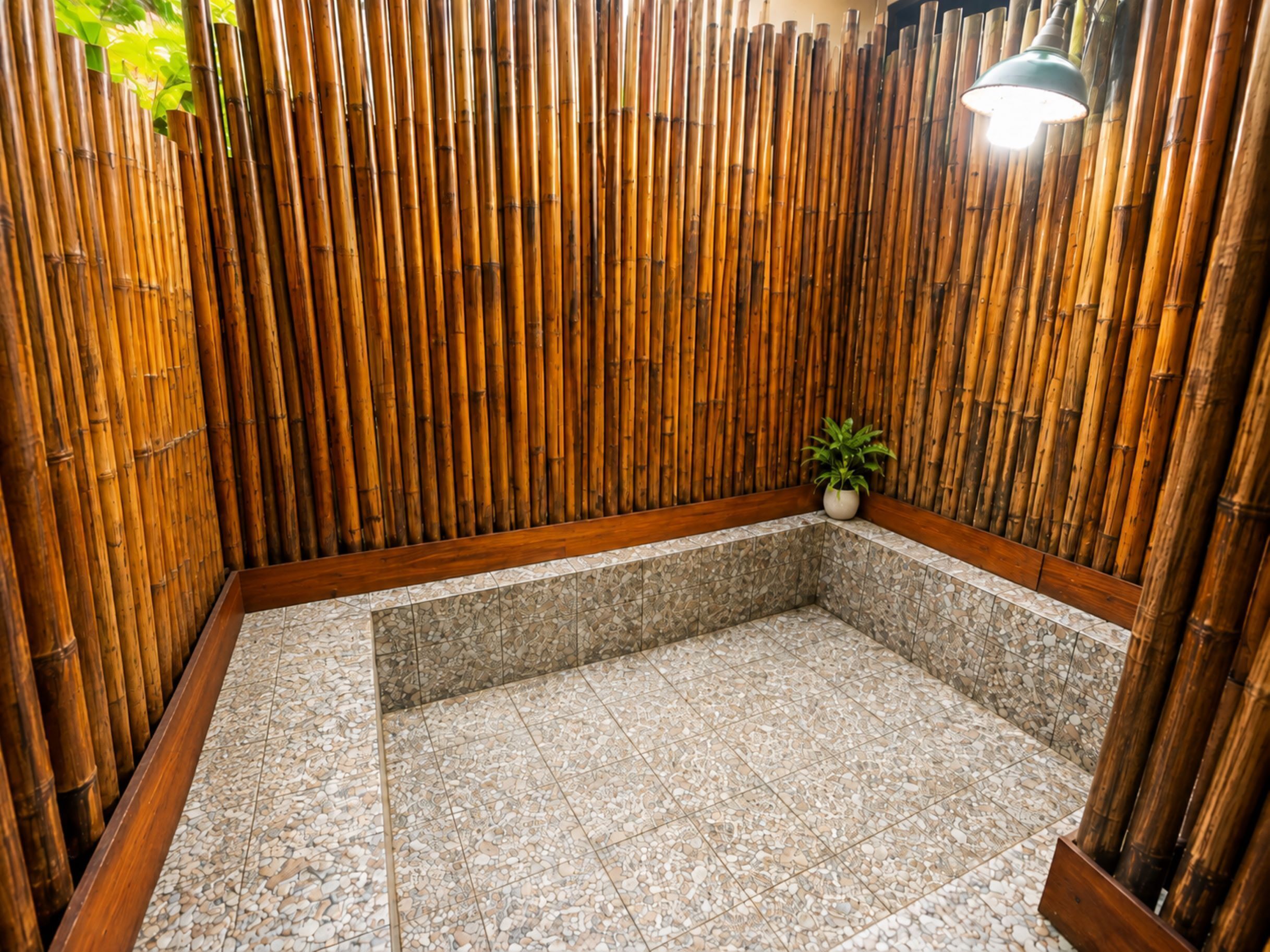 A spa area with a tiled floor, wooden wall, and a small plant.