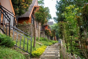 A residential area with a staircase leading to a wooden house with a balcony. - Savia Hotel & Resort Ciater (Ciater)