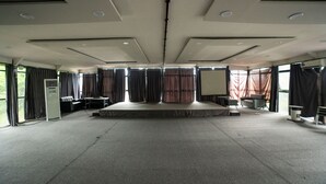 A large, empty room with a stage, curtains, and a carpeted floor. - Savia Hotel & Resort Ciater (Ciater)