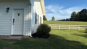 A white building with a door, windows, and a small porch area.