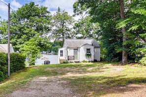 A house with a front porch, a small deck, and a view of a body of water. - Dock & Sunset Views! Waterfront Thompson Getaway (Thompson)