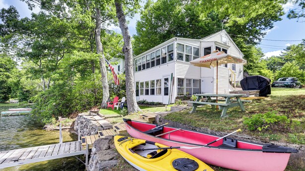 A lakeside cabin with a dock, kayaks, and a picnic table. - Dock & Sunset Views! Waterfront Thompson Getaway (Thompson)
