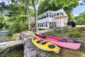 A lakeside cabin with a dock, kayaks, and a picnic table. - Dock & Sunset Views! Waterfront Thompson Getaway (Thompson)