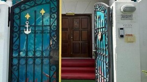 A gated entrance to a building with a sign reading 'LUNAR ORBIT VACATION HOMES RENTAL LLC.'