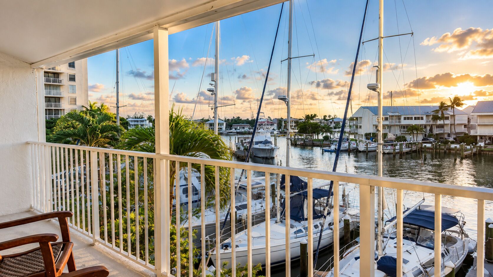 A balcony with a view of a marina and buildings.