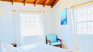 A bedroom with a bed, a chair, and a window. - Endless Summer - by ZenBreak (Inch Marlow)