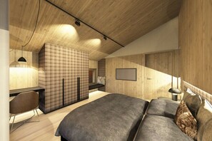 Ein modernes Schlafzimmer mit einem großen Bett, einem Schreibtisch und einer Sitzecke.