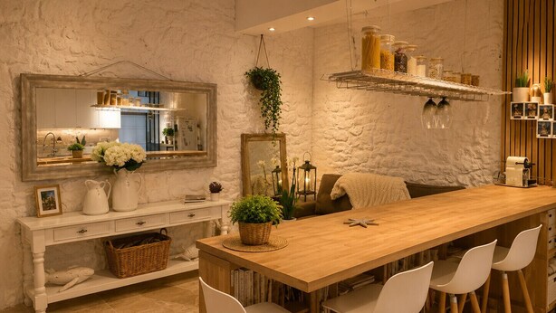 A kitchen with a wooden table, white chairs, a hanging plant, and a mirror. - 16624498LIONS Le Suquet Old Town Forville Cozy Apartment (Cannes)