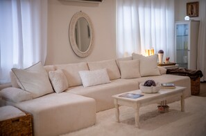 A living room with a beige sofa, a round mirror, a coffee table, and a lamp. - Holly House, your Portal to Mt. Shasta Bliss. (Mount Shasta)