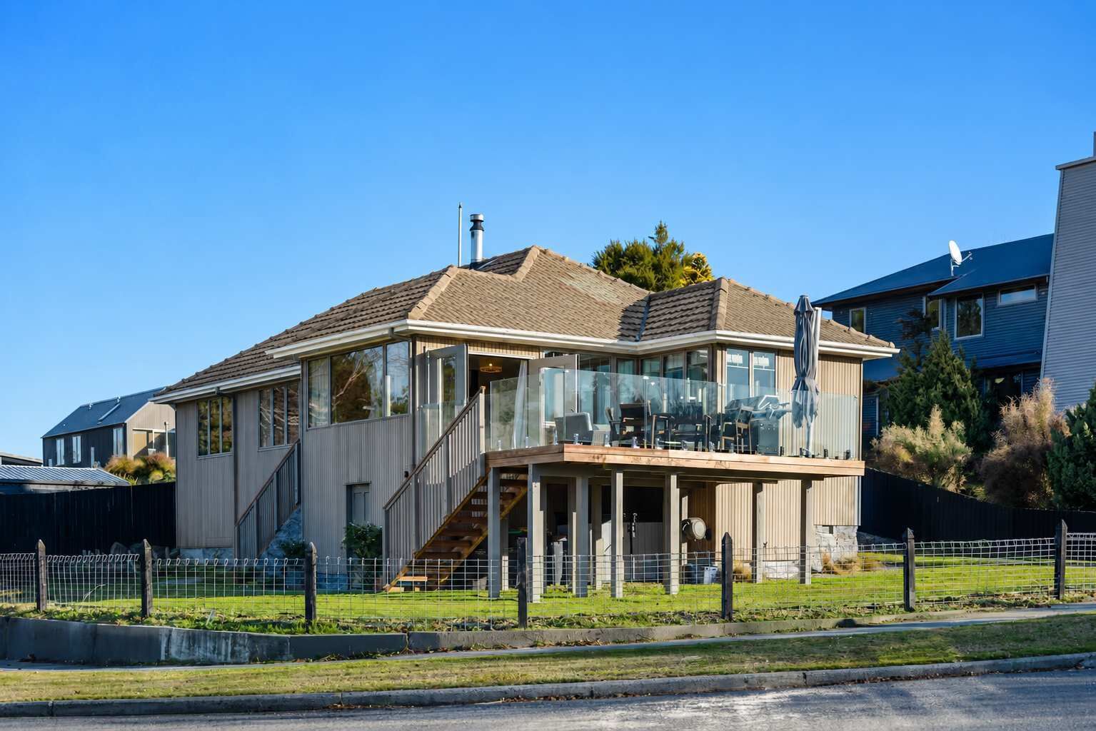 A two-story house with a covered porch and a visible staircase.
