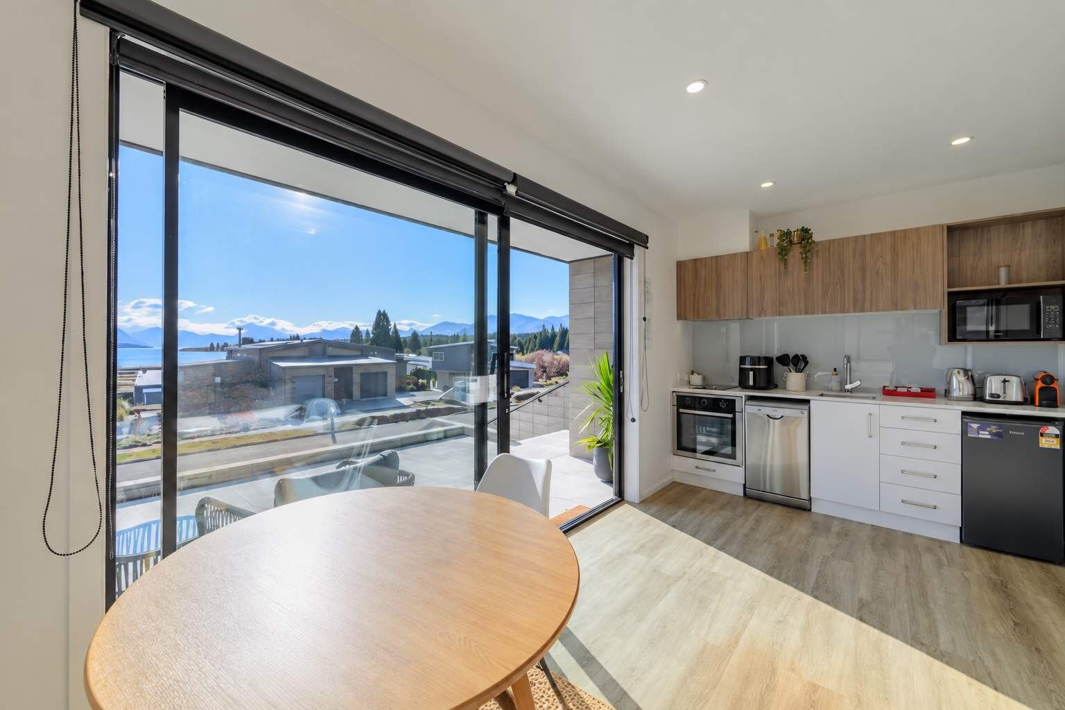 A modern kitchen with a view of a mountain landscape.