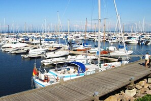 A marina with numerous boats docked, wooden piers, and calm water. - Hohen Niendorf Castle (Hohen Niendorf)